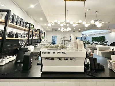 The bright Dock19 counter and dining room beneath pendant lights.
