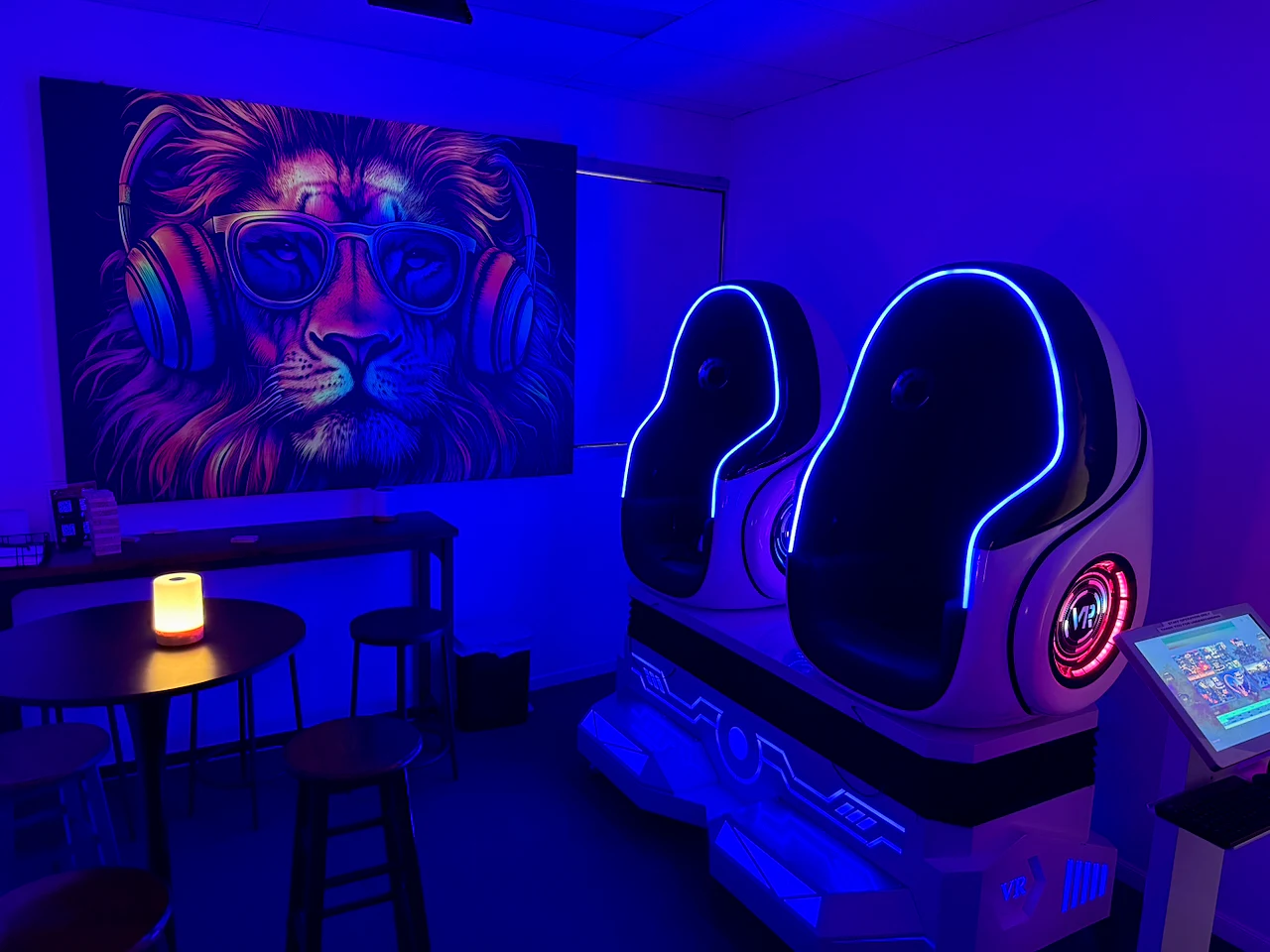 Two blue-lit virtual-reality motion pods inside the venue.