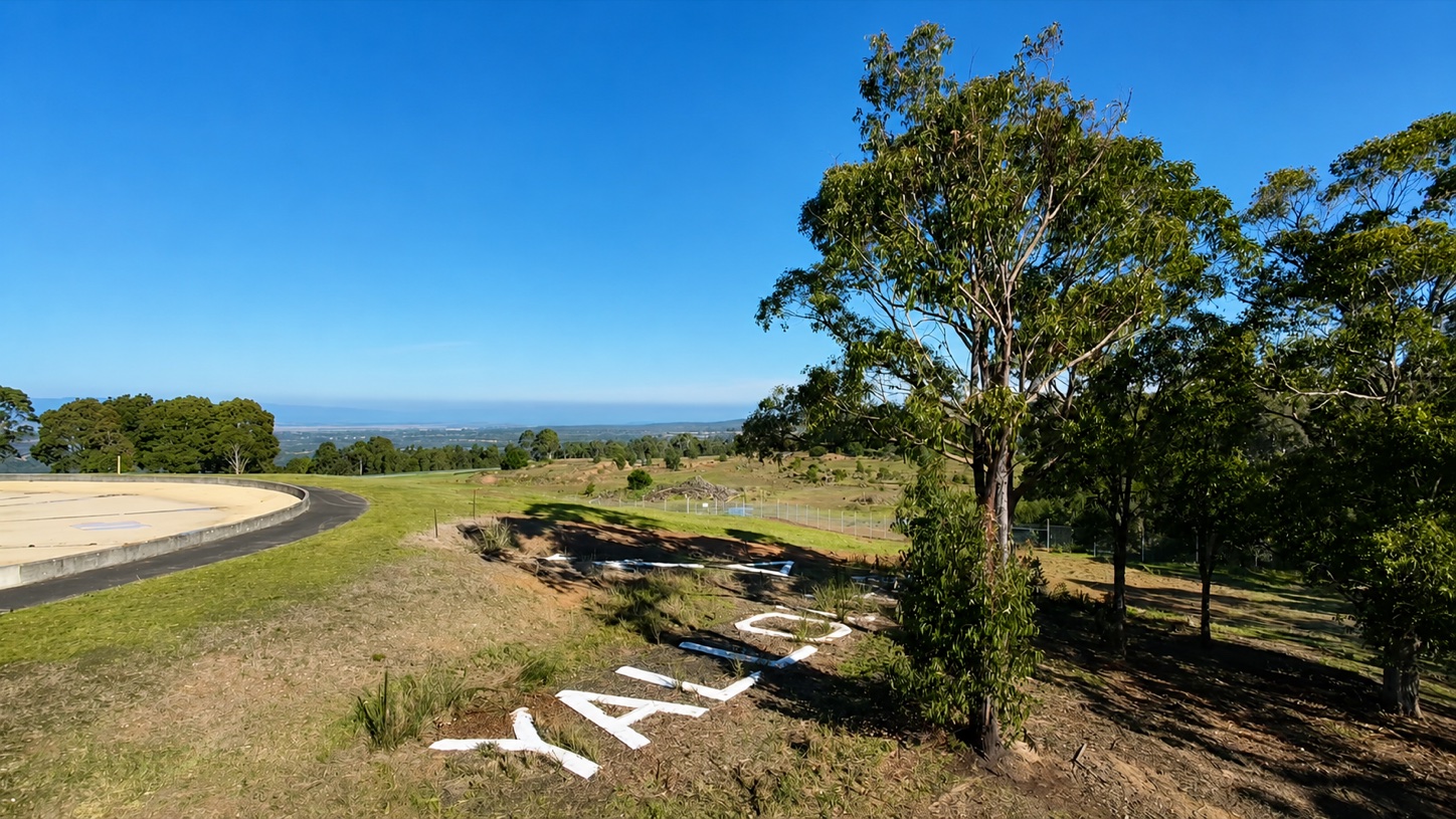 The Yallourn Aerial Navigation Marker in 2026, with its concrete letters and numeral 4 visible on the hillside beside trees.