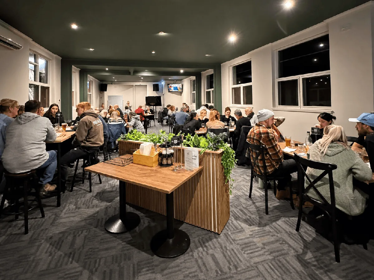 Patrons seated at tables in the Newborough Hotel dining room.