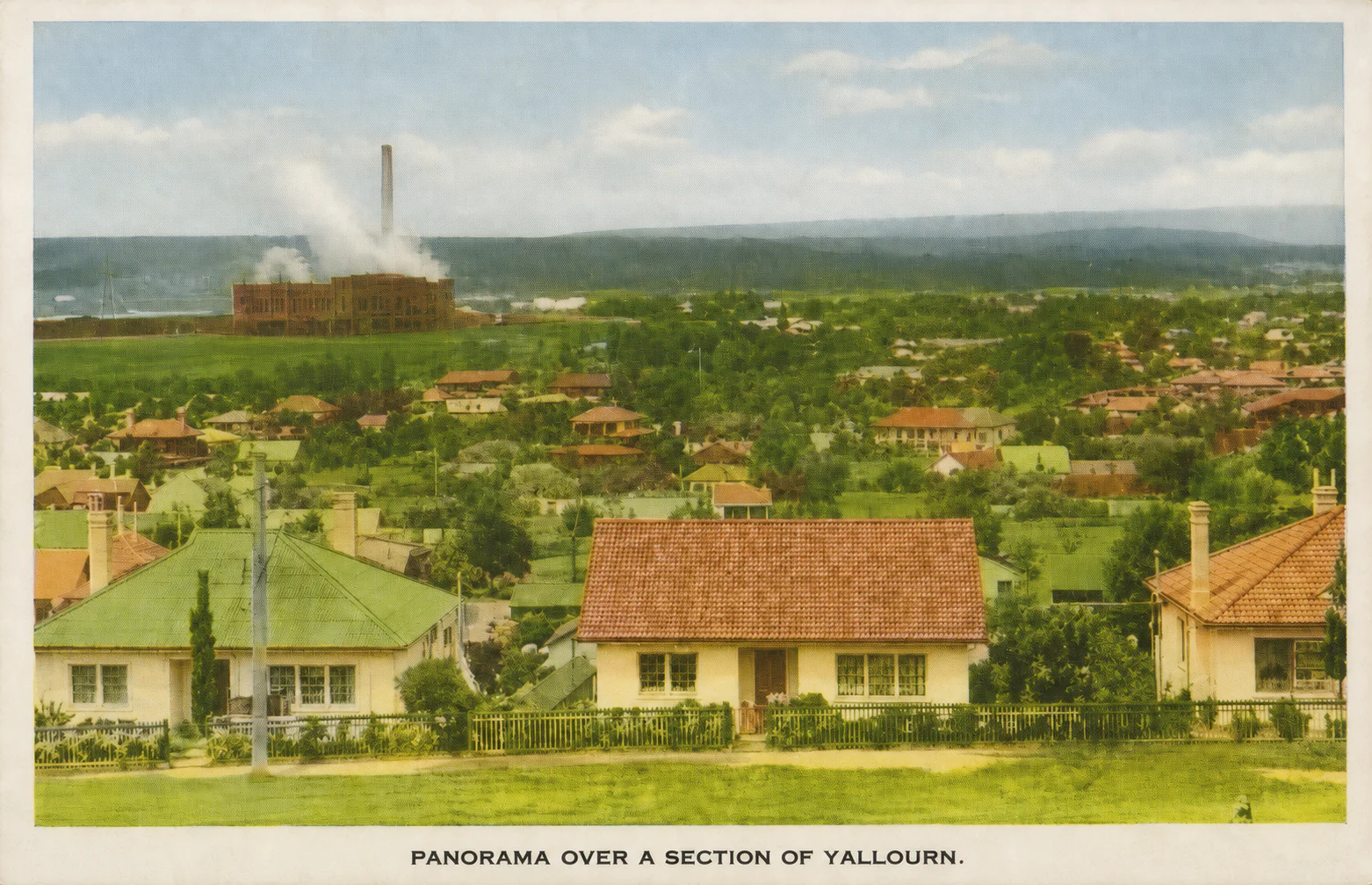 Colour-restored postcard view across Yallourn houses and gardens towards the power station.