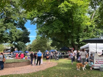Market stalls are arranged beneath the trees at Traralgon Craft Market.