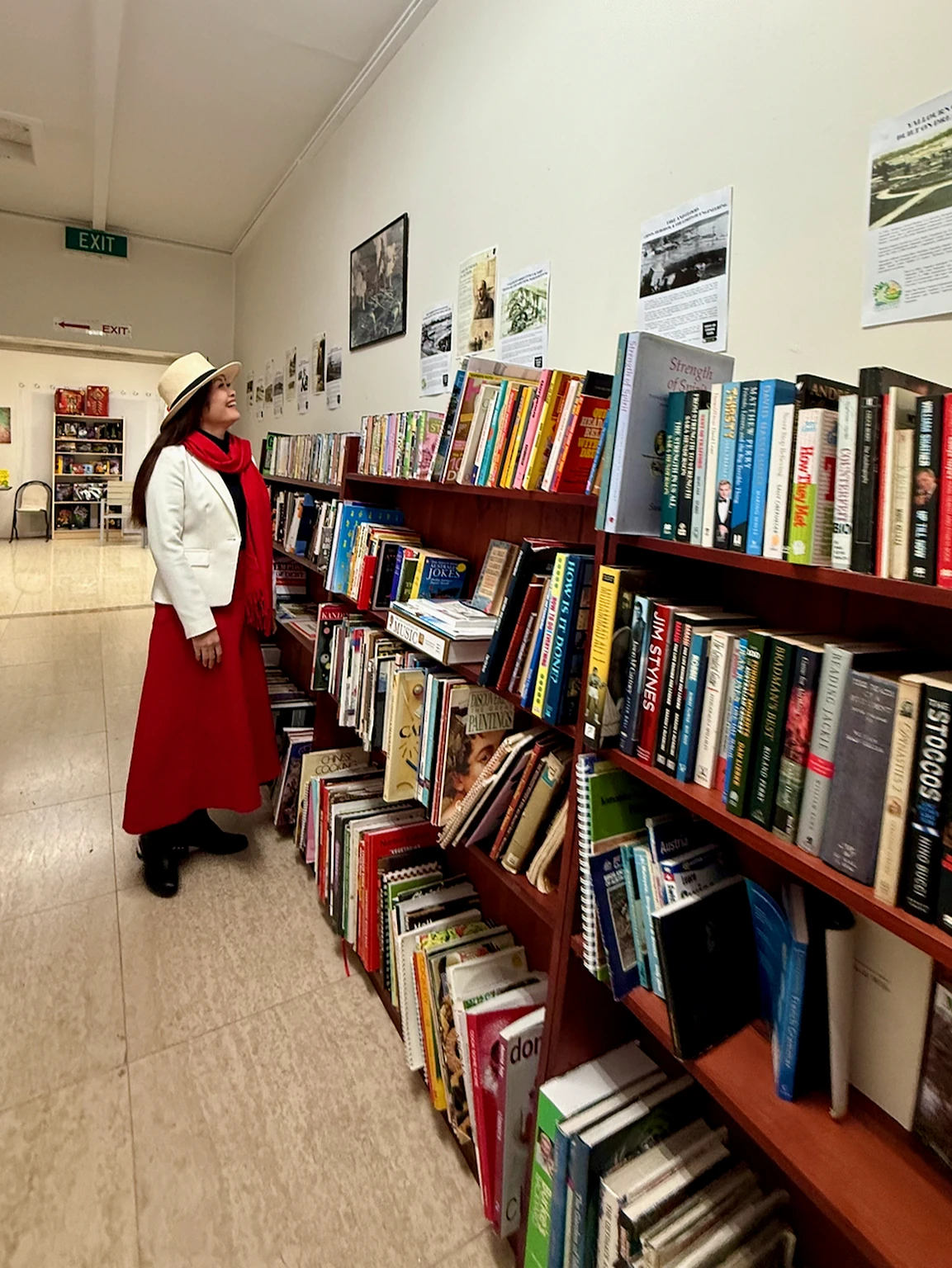 Visitor browsing books and historical interpretation panels inside Yallourn Production Centre.