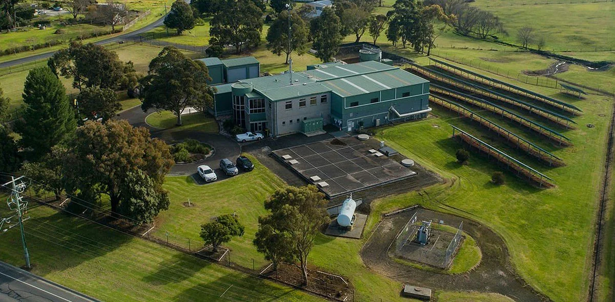 Aerial view of the Traralgon water-treatment facility among trees and open grassland.
